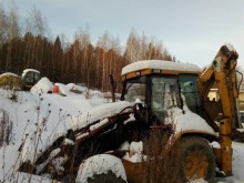 экскаватор-погрузчик с сочлененной рамой Caterpillar